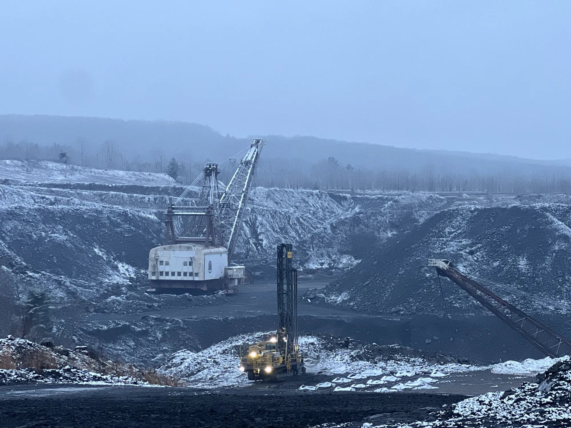 Dragline working a coal pit in winter fog