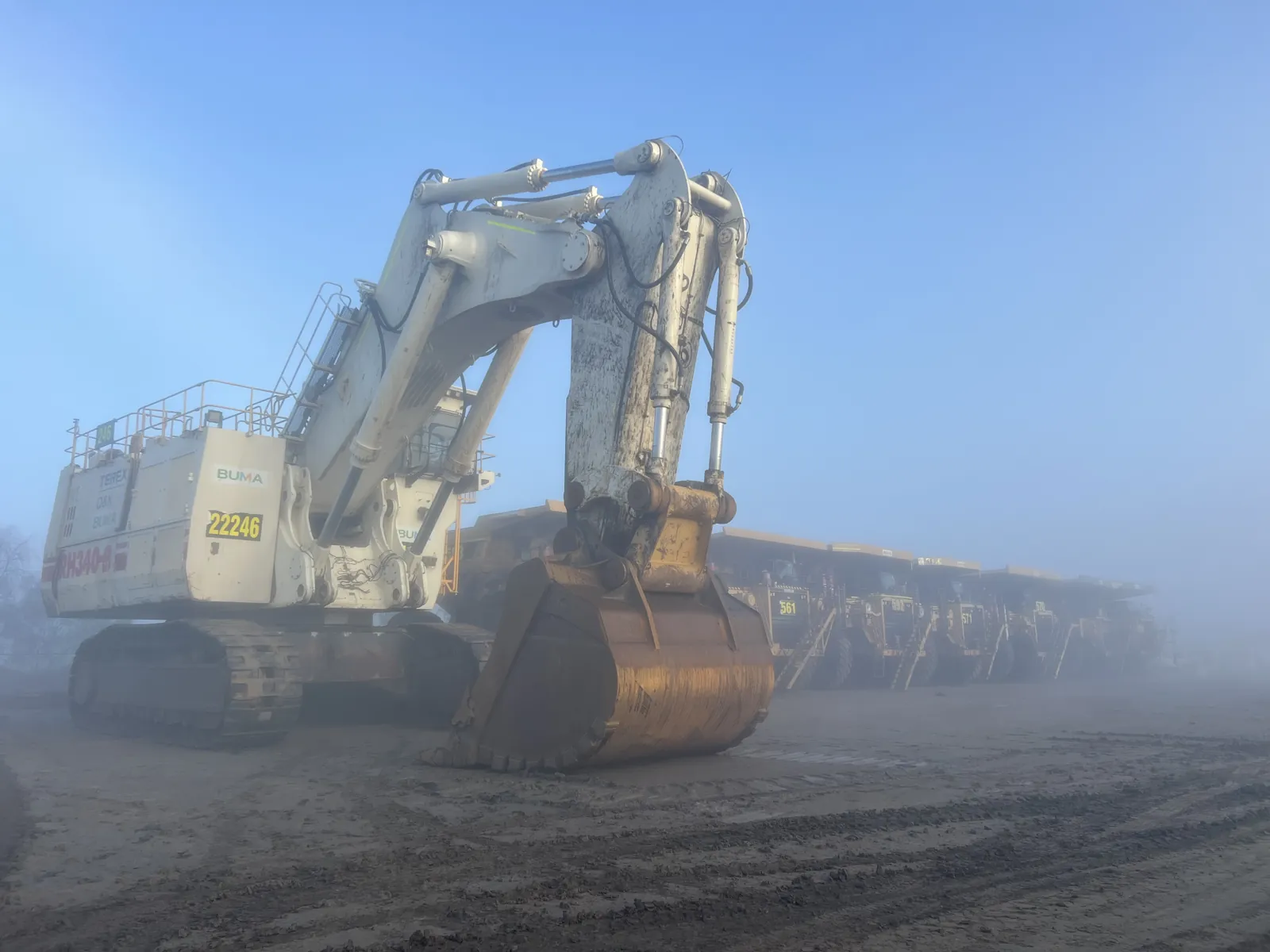 Liebherr excavator and haul trucks in fog
