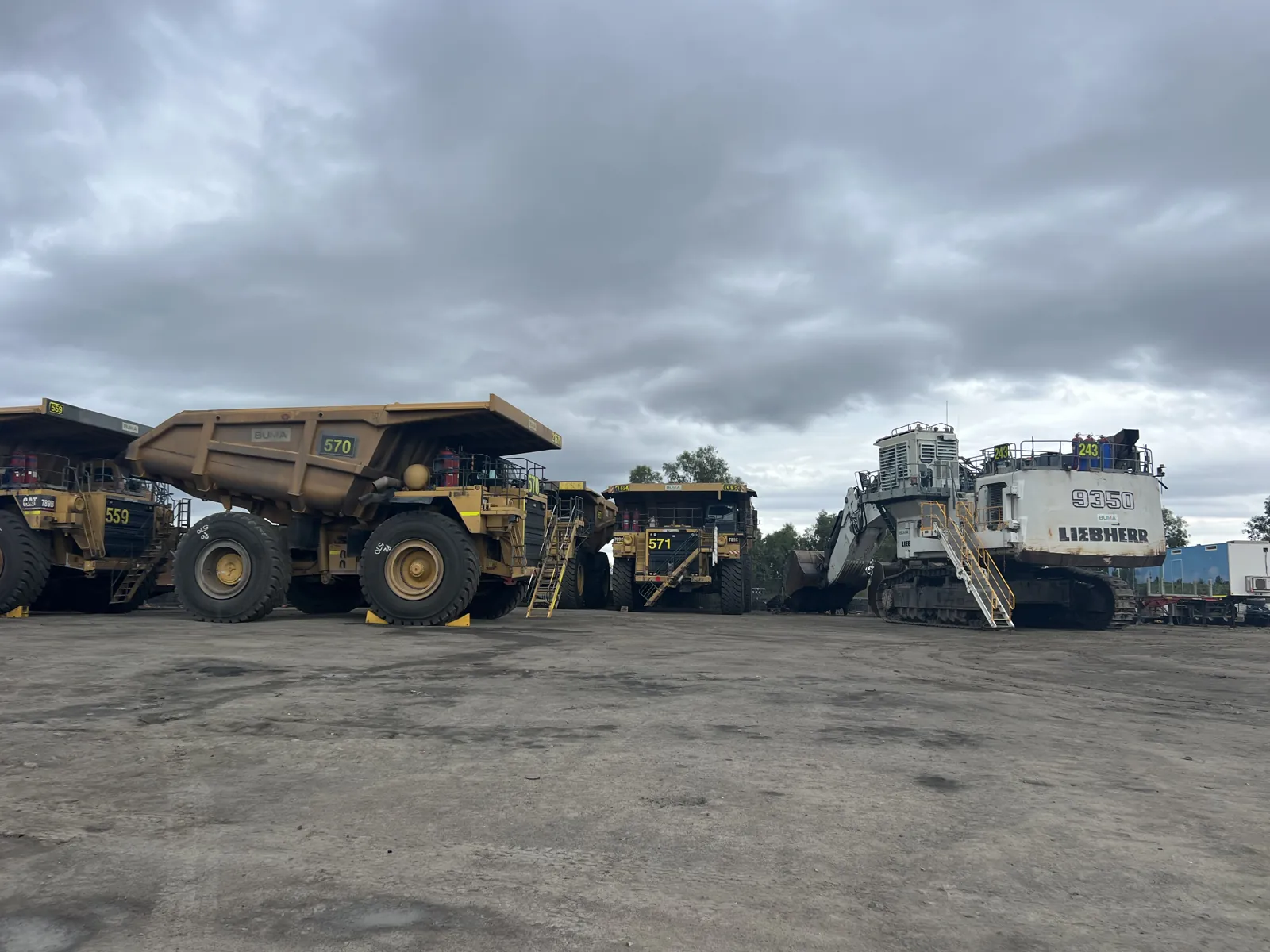 Haul trucks and a Liebherr excavator in the yard