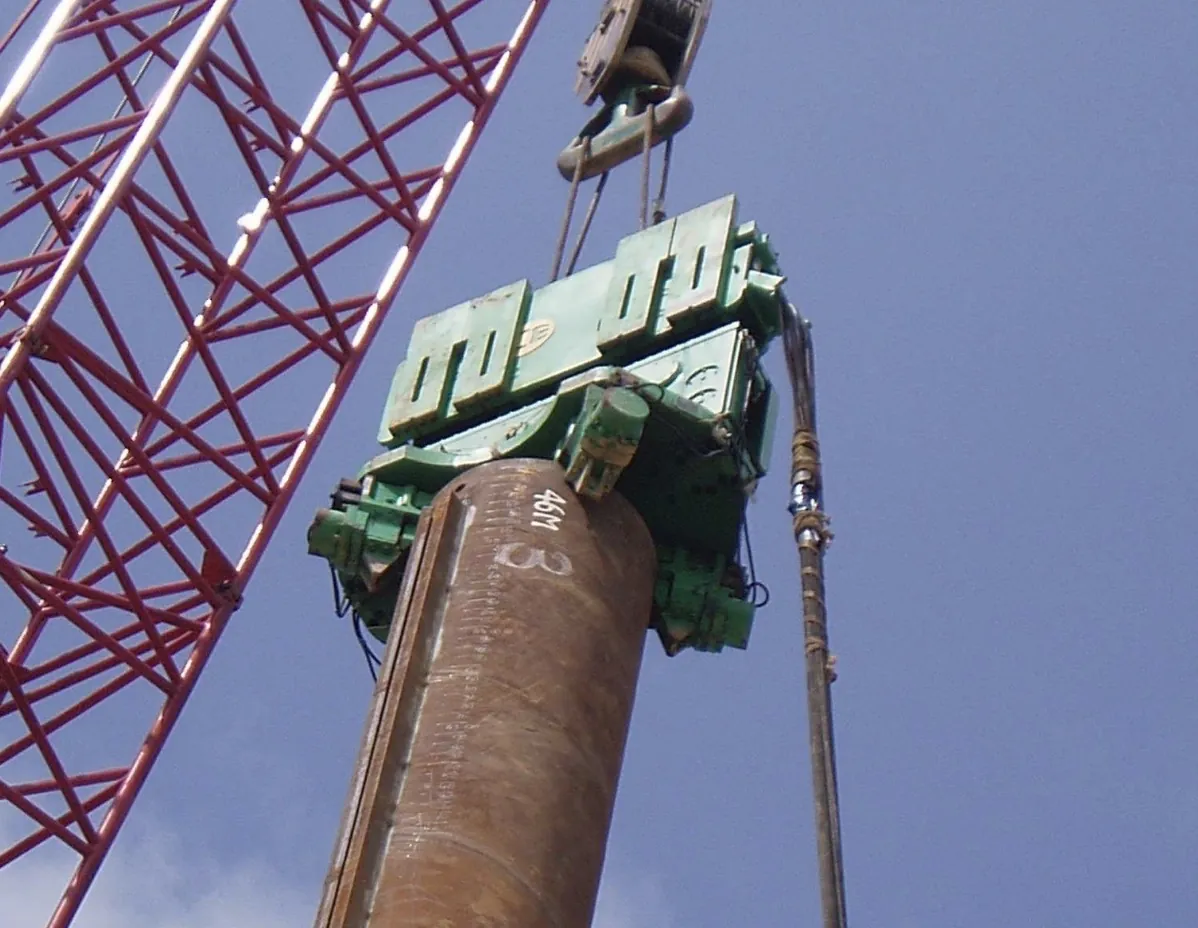 Crane lifting a pile casing