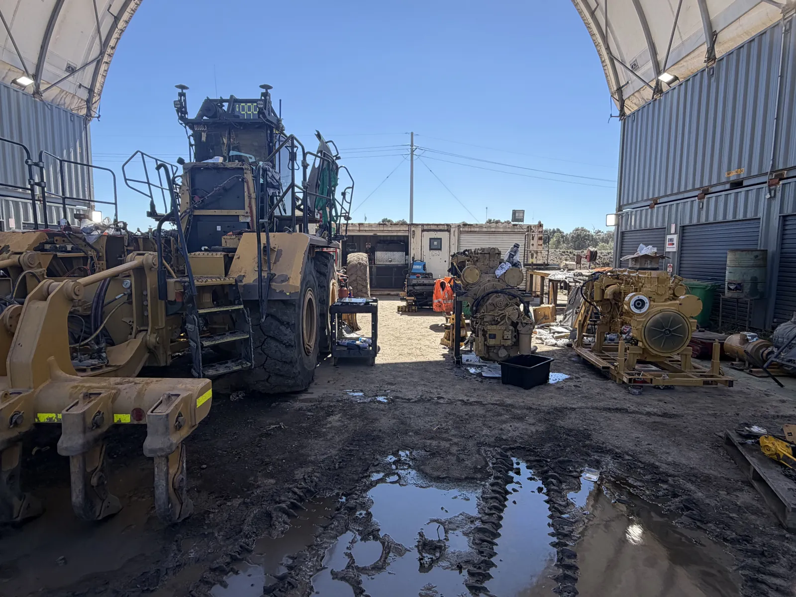 Loaders and dozers lined up in the yard