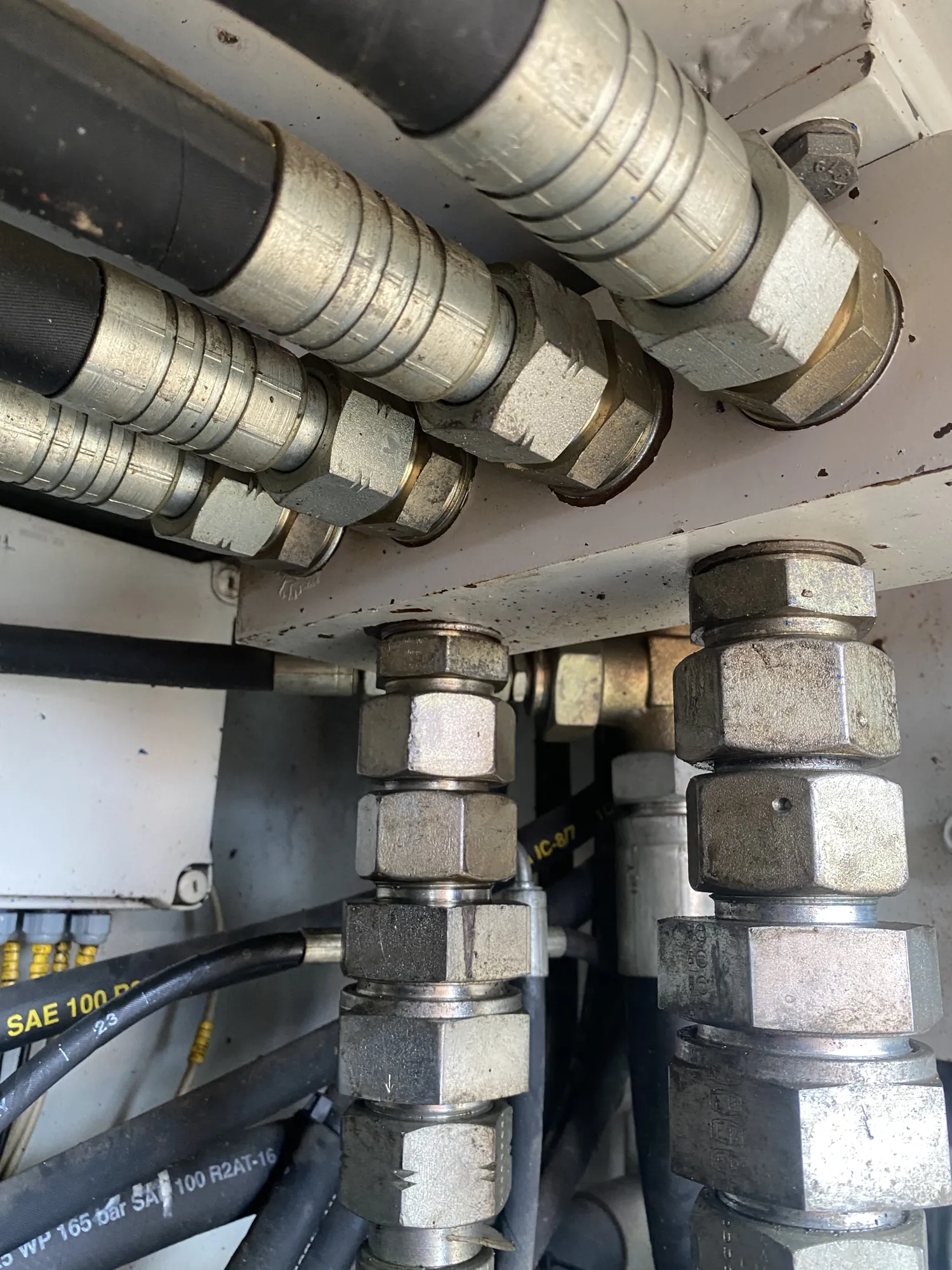 Bank of hydraulic hoses and fittings on heavy equipment